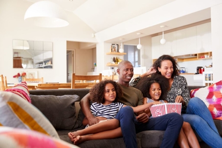 family sitting on couch together