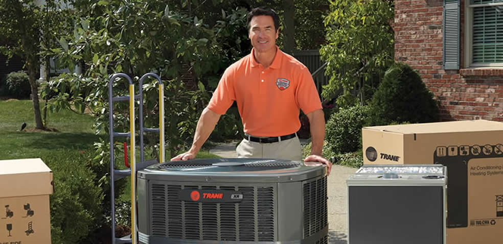 Trane Dealer On Lawn With Several Boxed And Unboxed Ac Heating Units