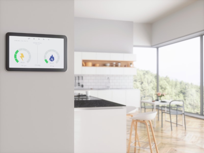Smart Thermostat Displaying Eco Settings With Modern Kitchen In Background